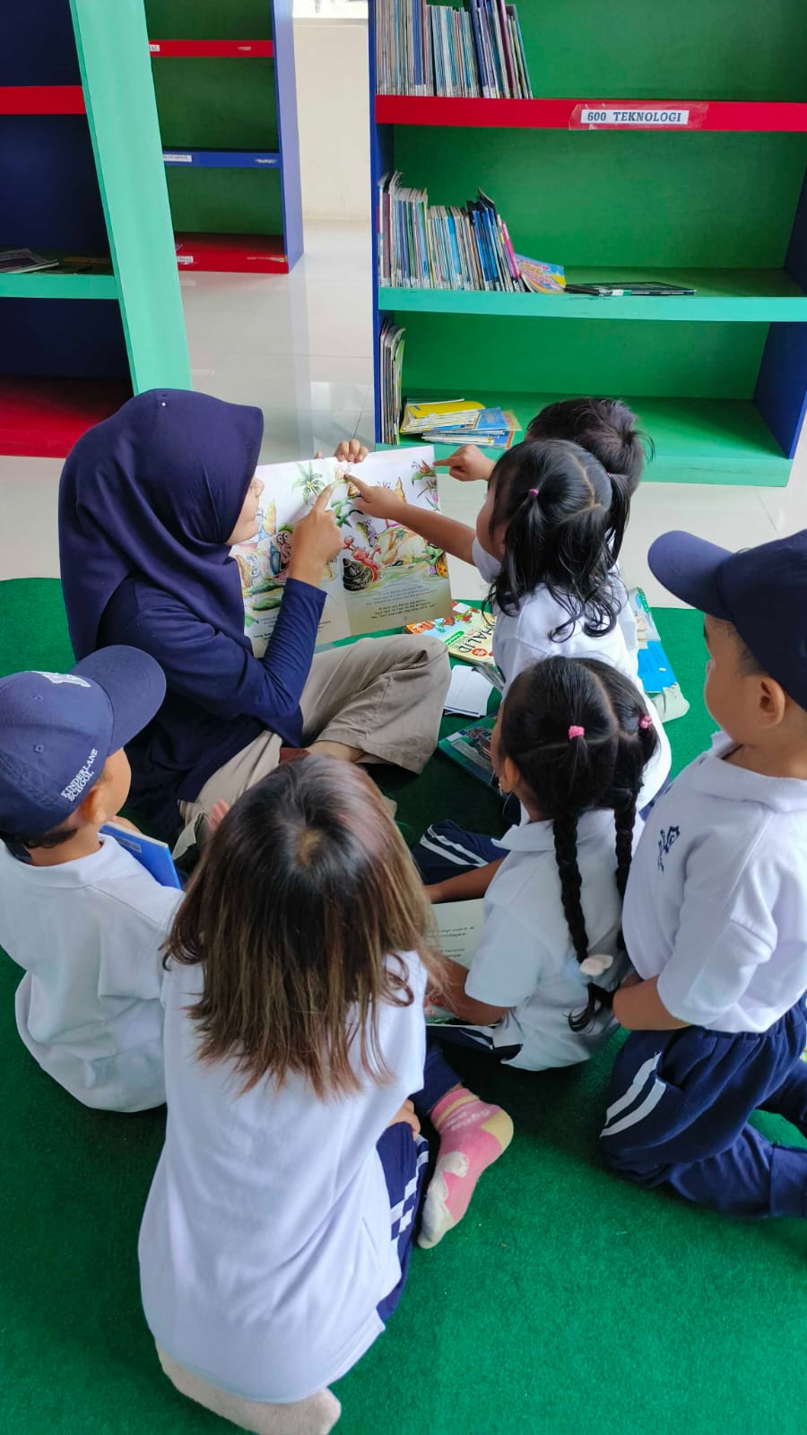 Children exploring books in library