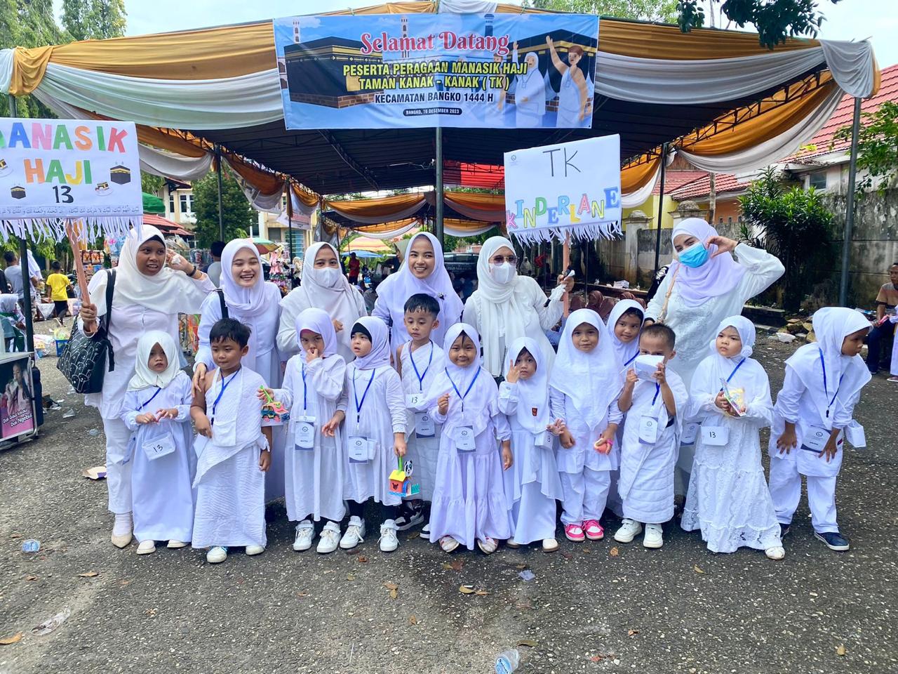 Children learning Hajj ceremony preparation